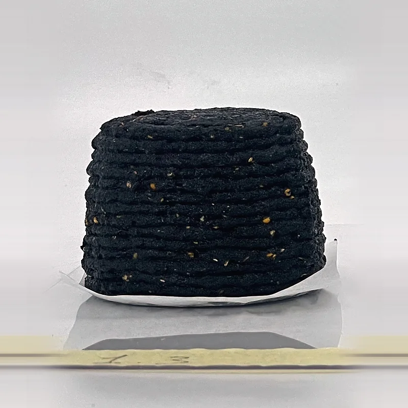 Short printed cylinders from the same batch, from fresh black paste to white with mycelium