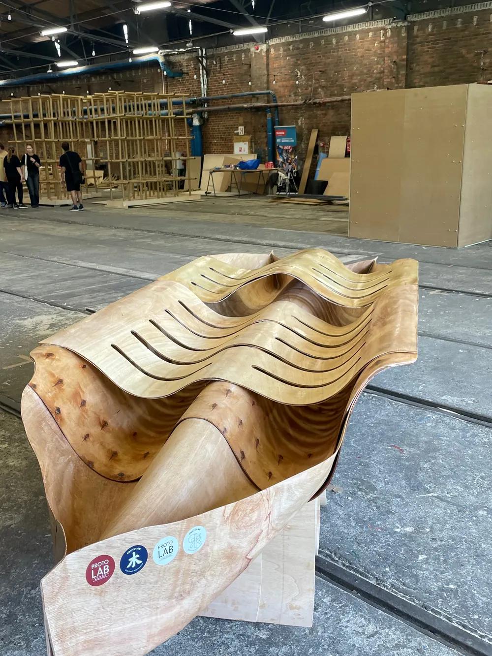 The canoe standing on its supports in the workshop hall