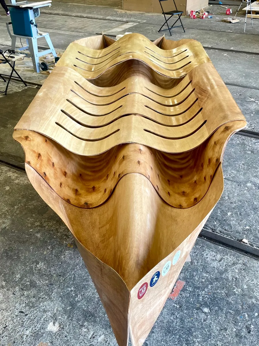 The canoe from above, its laminated layers stepping in waves towards the bow