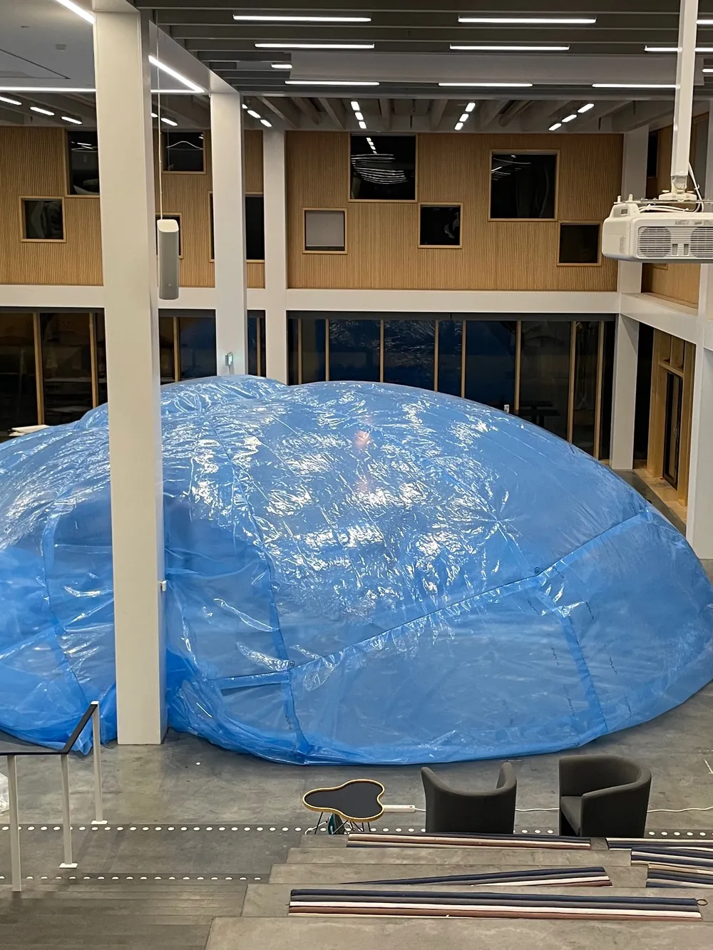 The blue membrane inflated indoors, filling the atrium of the Arts Campus