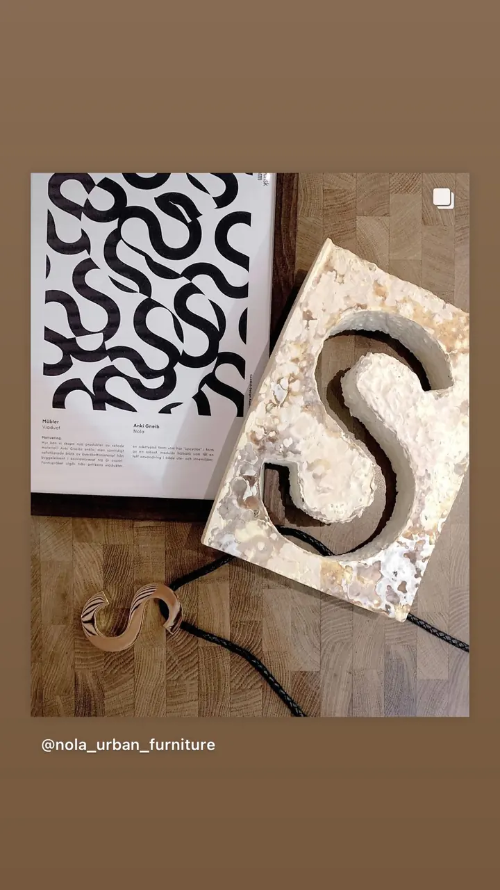 Story: an S trophy next to a black and white pattern